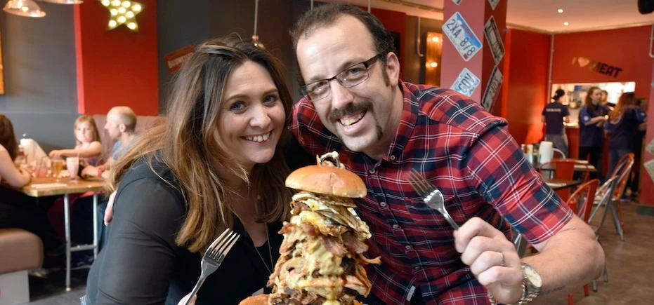 Huckleberry's owners Jon & Sarah Rowlands tuck into 'Burgerpockalypse'.