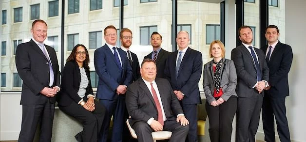 Richard Sunderland (seated) and the CBRE promoted staff. 