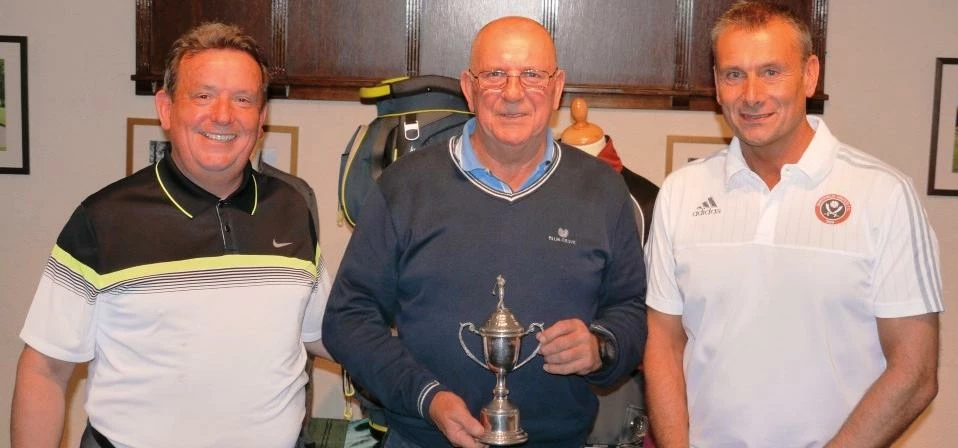 Stephen Scott, winner of Martin-Brooks' charity golf day (centre) is presented with his prize by Joh