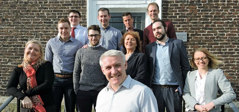 Geoff Thompson (front) and the Posturite team outside their new base in the Manor House, Sedgefield