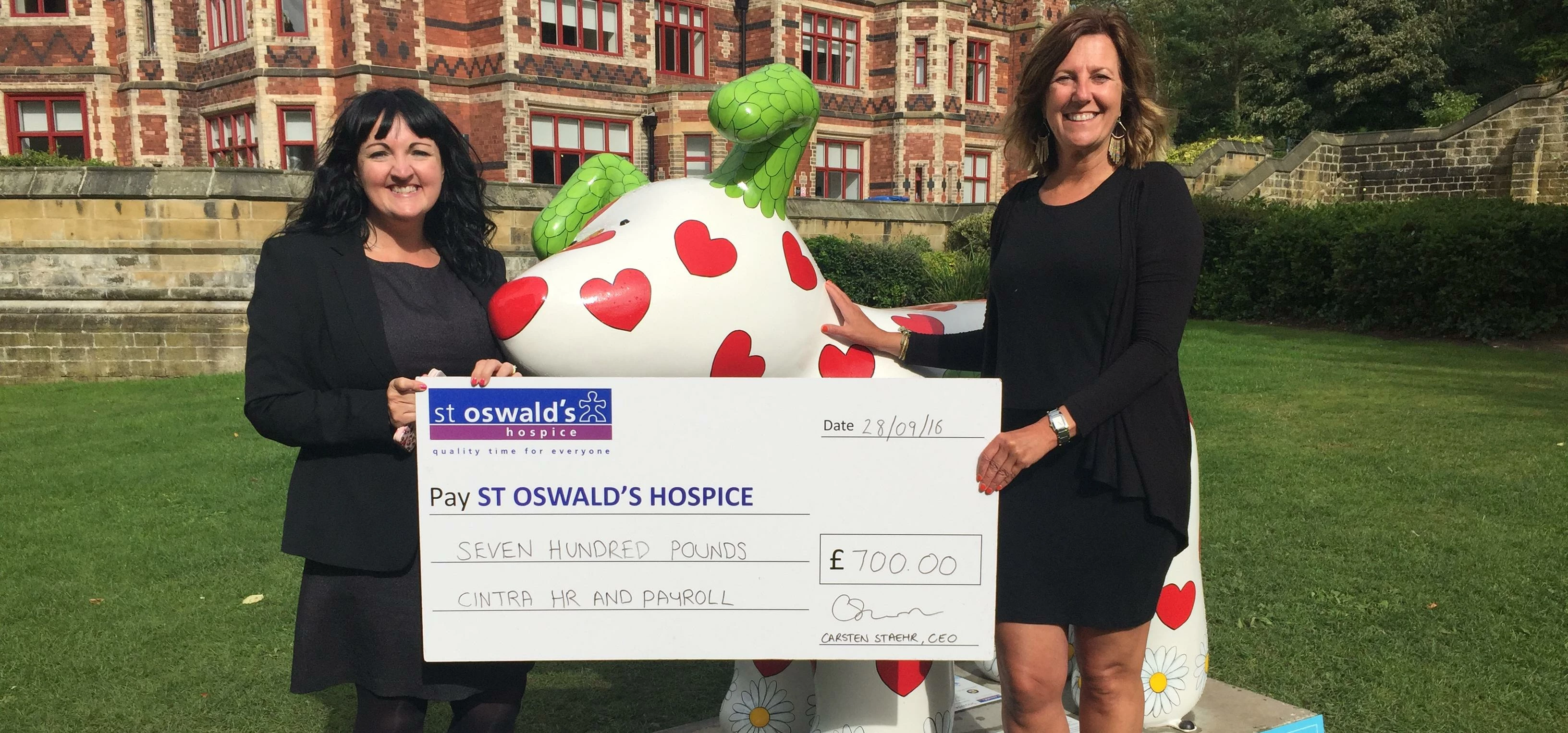 Siobhan Sargeant of St. Oswald's Hospice receiving the cheque from Alexandra Watt, Cintra HR & Payro
