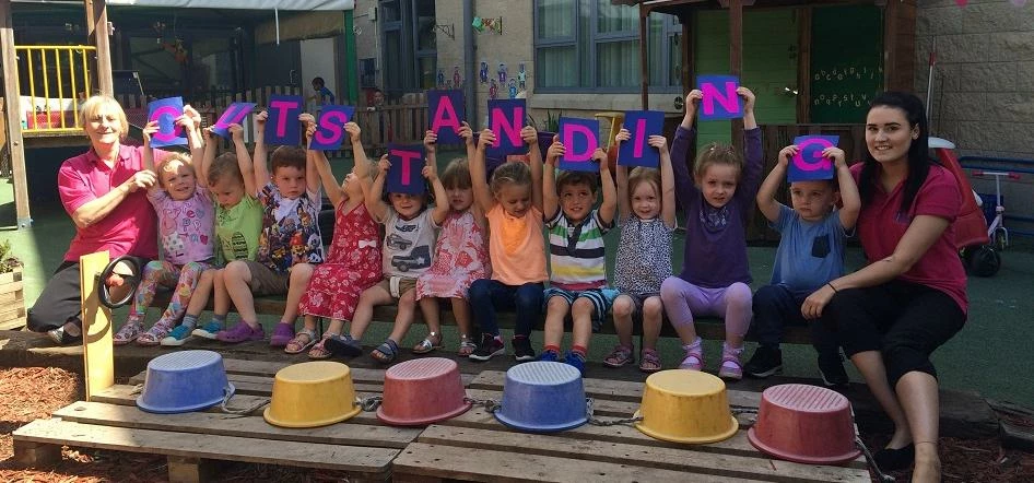 Children at Tinies Cheltenham celebrate the team's success