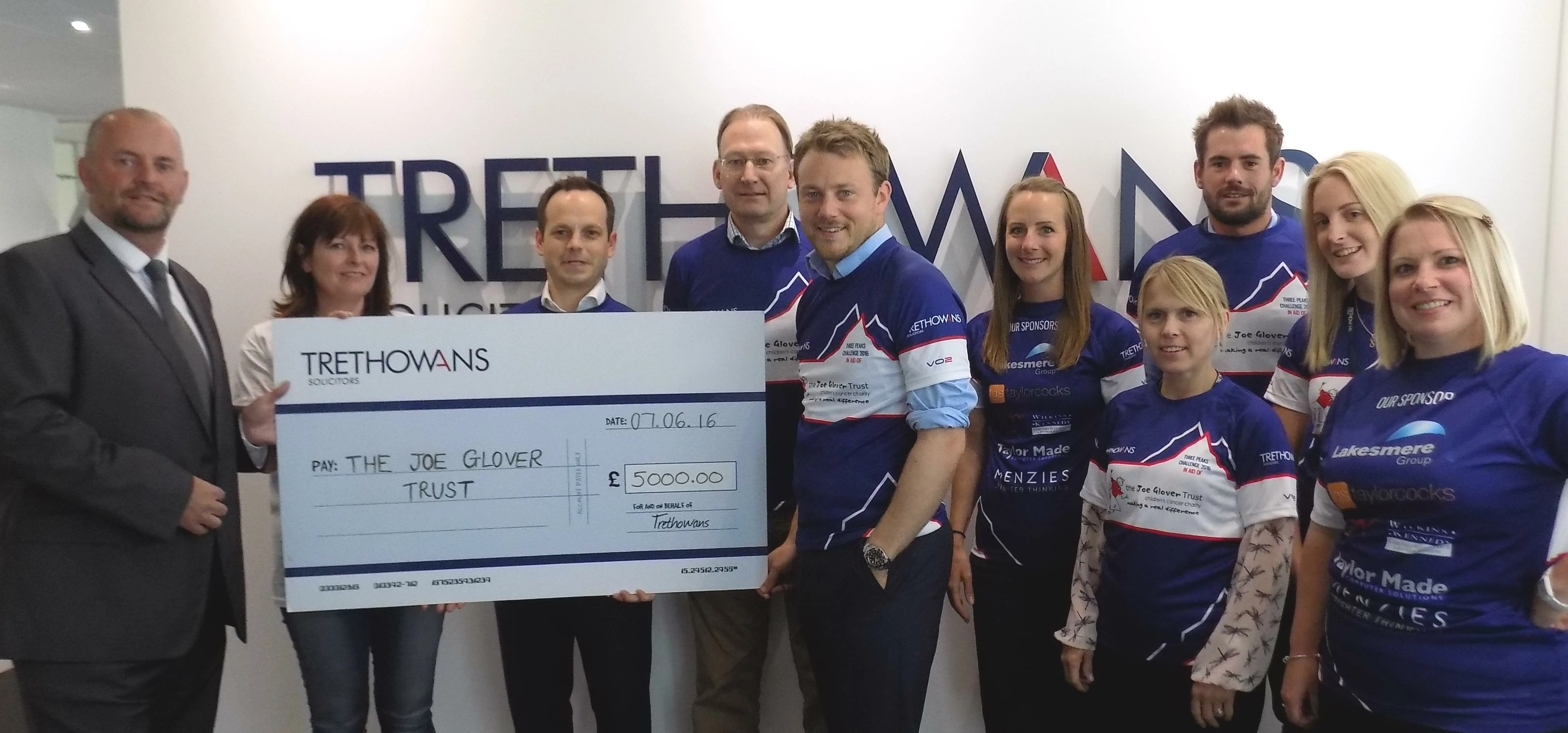 Staff from Trethowans present the money raised from the Three Peaks Challenge