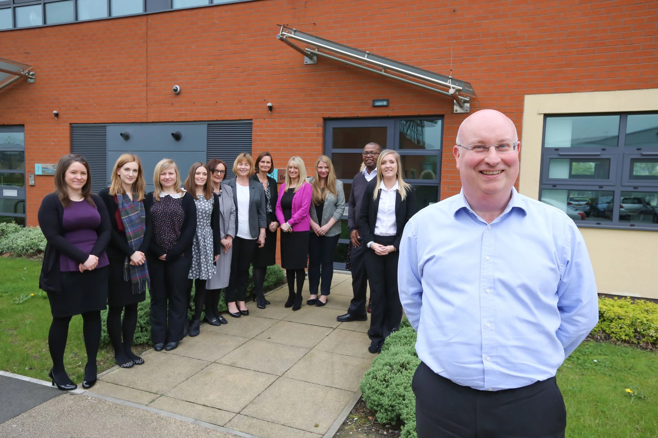 Neil Atkinson, managing director at Deminos, with members of his team.