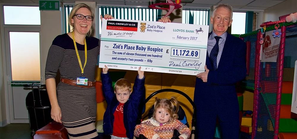 Paul Crowley presents a cheque to Zoe's Place Baby Hospice