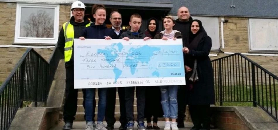 Arran Bailey from ALB Investments Ltd (back right), presents the cheque to the representatives from
