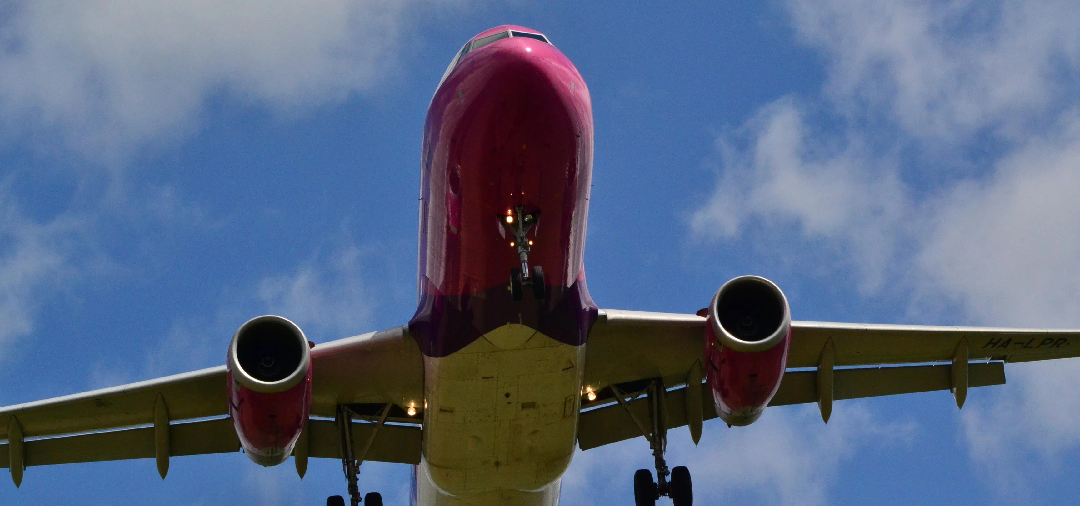 Wizz Air HA-LPR A320-232 jet flying overhead for landing