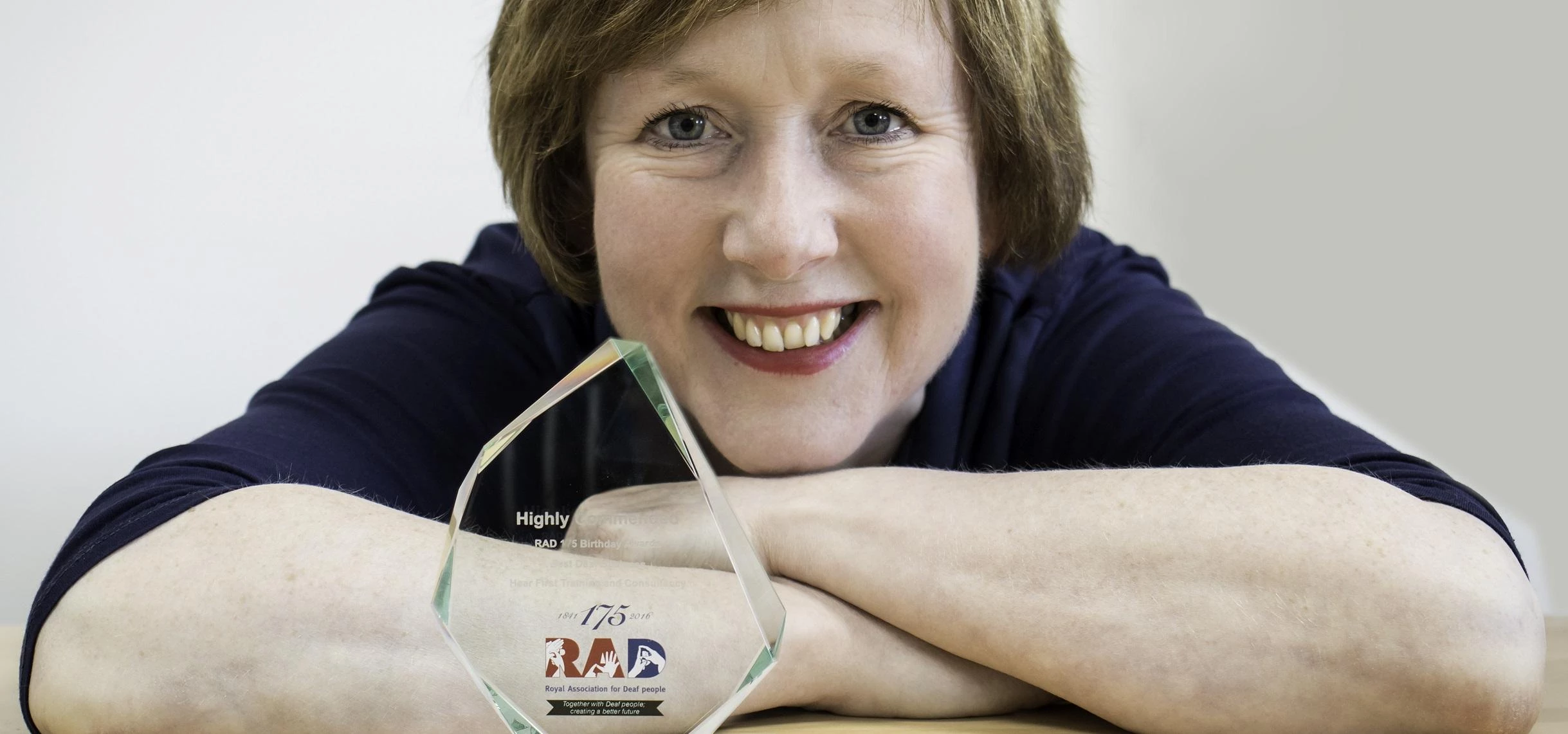 Julie Ryder, Director and Founder of HearFirst pictured with their latest award from the Royal Assoc