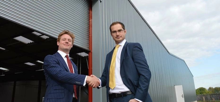 Nick Prescott of Knight Frank (left) with Matthew Brear of Dacres Commercial (right) outside the bui