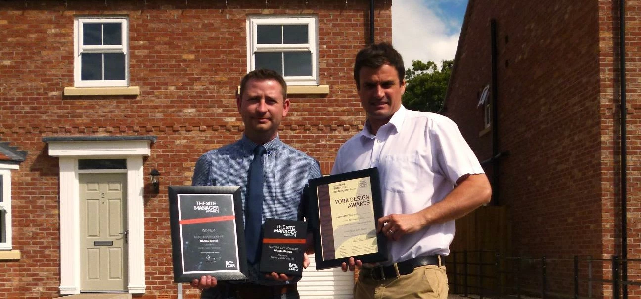 Daniel Baines (left) and Daniel Liddell pictured with the awards at the company’s award-wnning devel