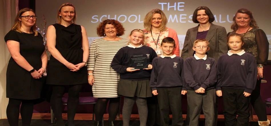 Pupils and staff from Eastlea Primary School collect their award from Councillor Susan Dungworth.