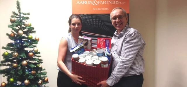 Aaron & Partners CEO Andy Duxbury and Paralegal Zoe Sherwin with some of the collection.