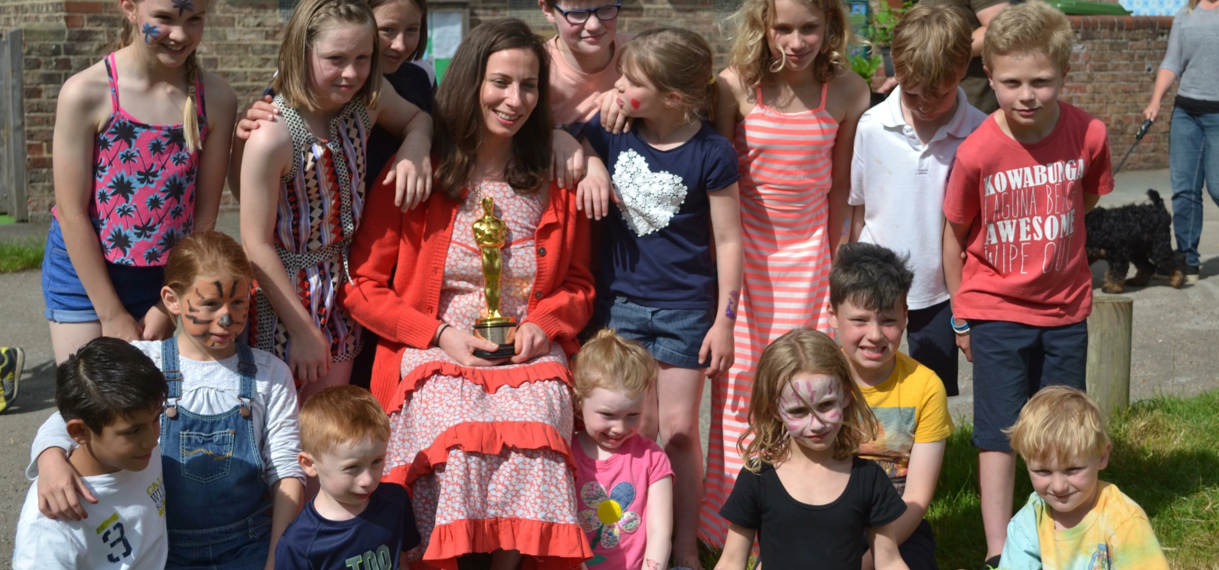 Oscar winner Serena with children at her old primary school in Nun Monkton, near York
