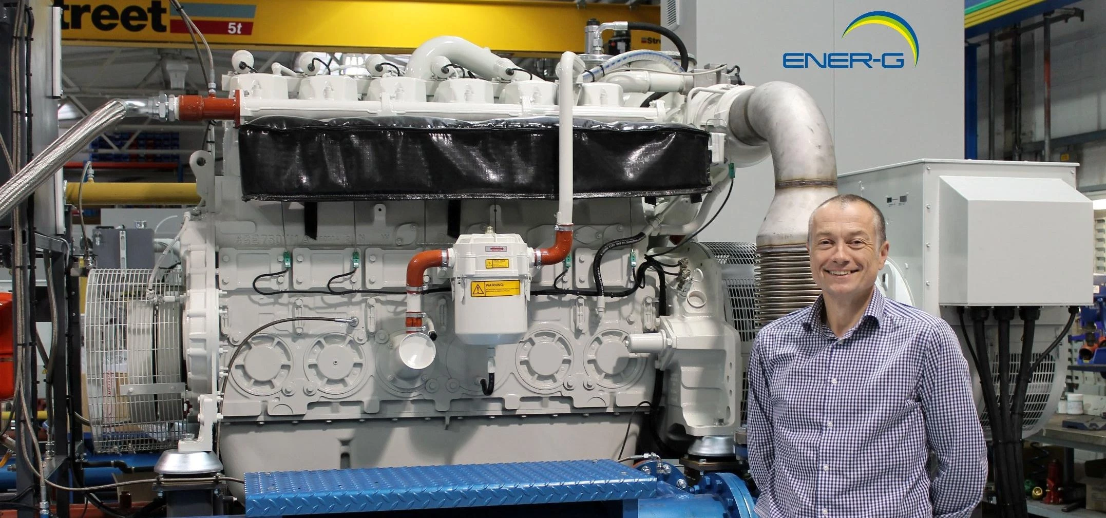 Chris Marsland, Technical Director of ENER-G Combined Power Ltd, with ENER-G CHP system