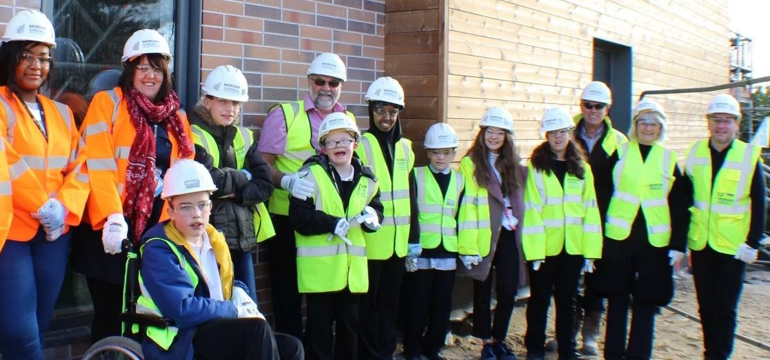 Staff and students at Oak Lodge School for Morgan Sindall's topping out ceremony.
