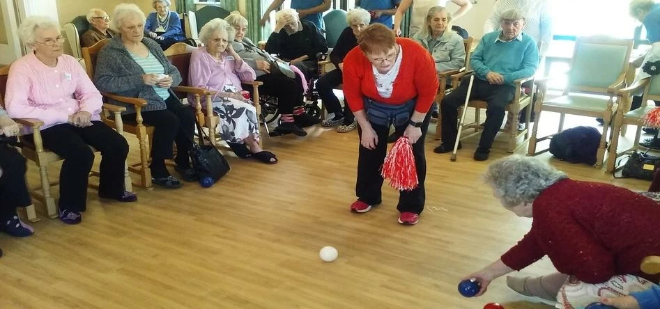 Residents and vistors taking part in a game of indoor bowls