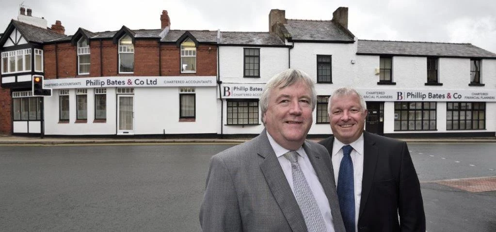 Phil Bates and Alan Mellor outside the new look Phillip Bates & Co offices 