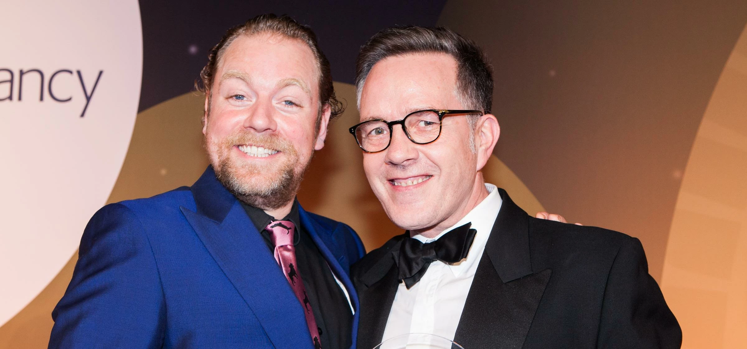 Comedian Rufus Hound handing the award to Geoff Woodhouse from Moore Stephens