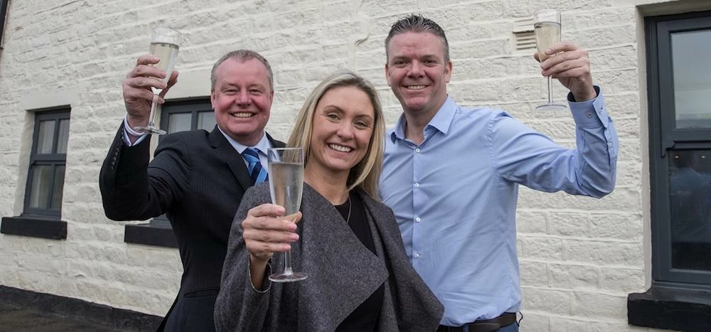 L-R: Reward Finance Group's Russell Holt with The Pack owners Jo-Ann and Karl Elsworth