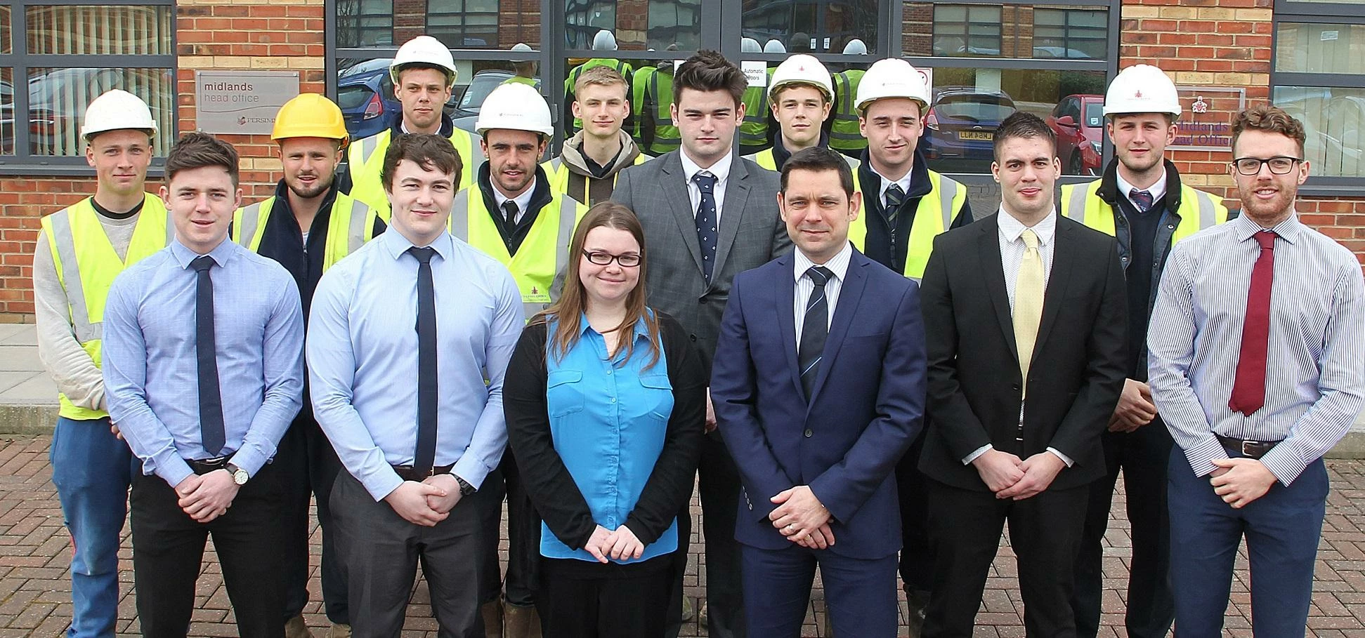 Persimmon Homes Midlands managing director Richard Oldroyd with trainees and apprentices at the comp
