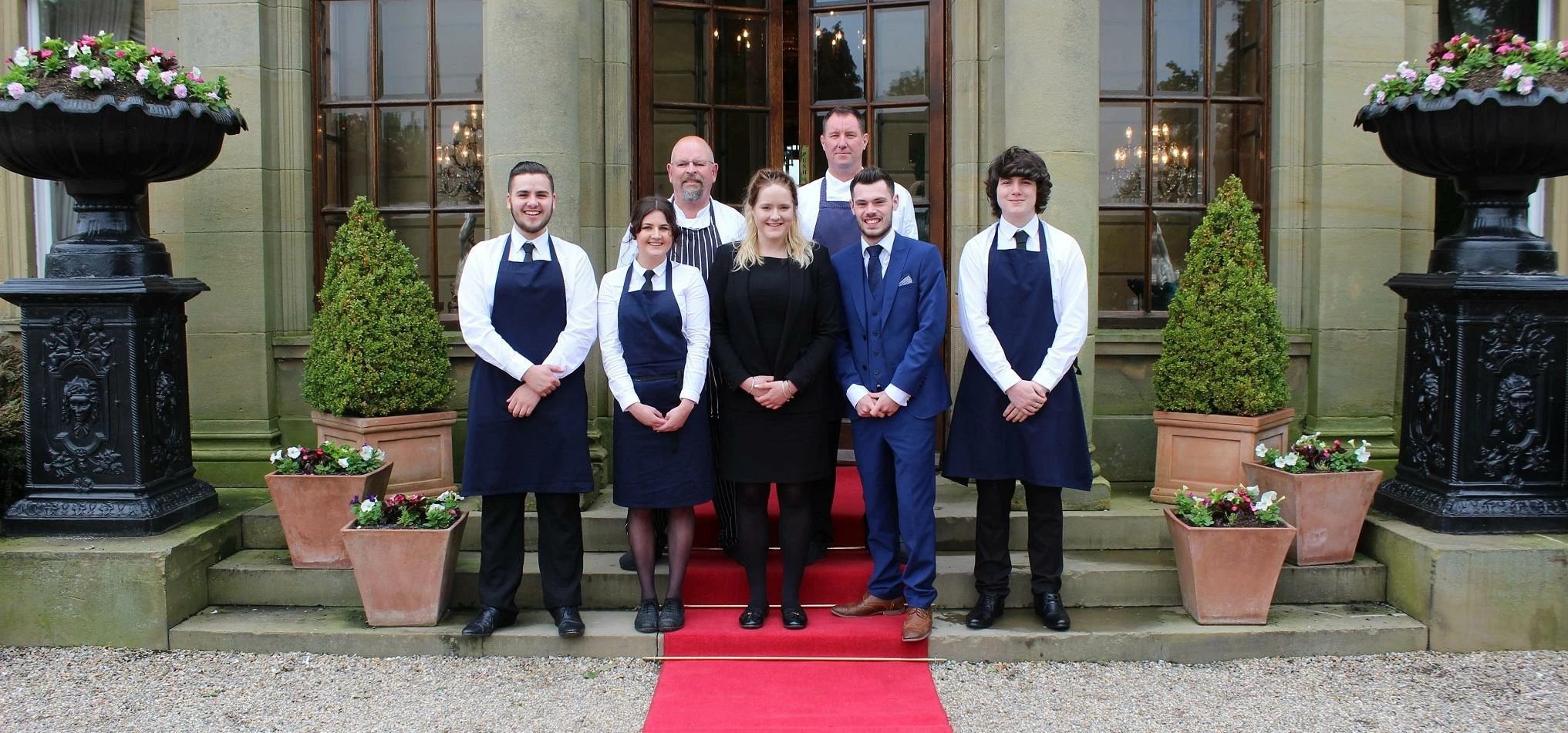 Joshua Angell (blue suit, second from right) and Paul Halifax (back row right)  with the Ninety-Nine