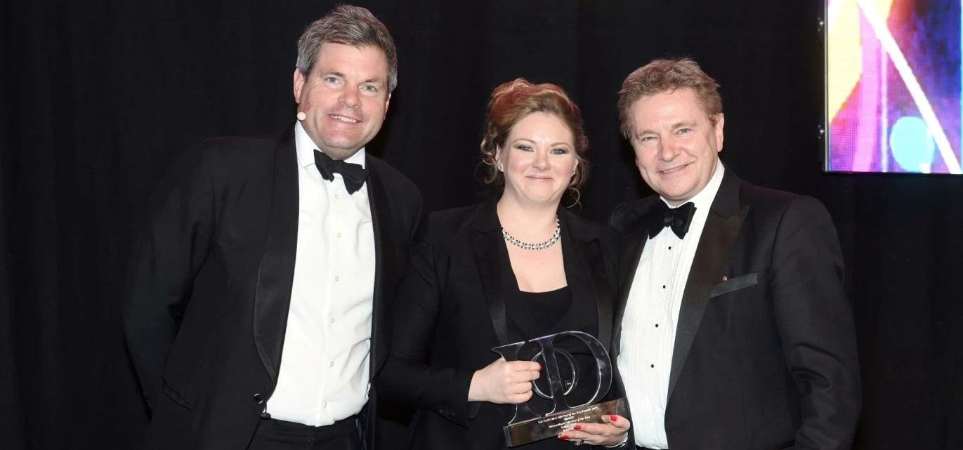 Emma Sheldon is pictured receiving her North West Institute of Directors' Award from TV presenter Ma