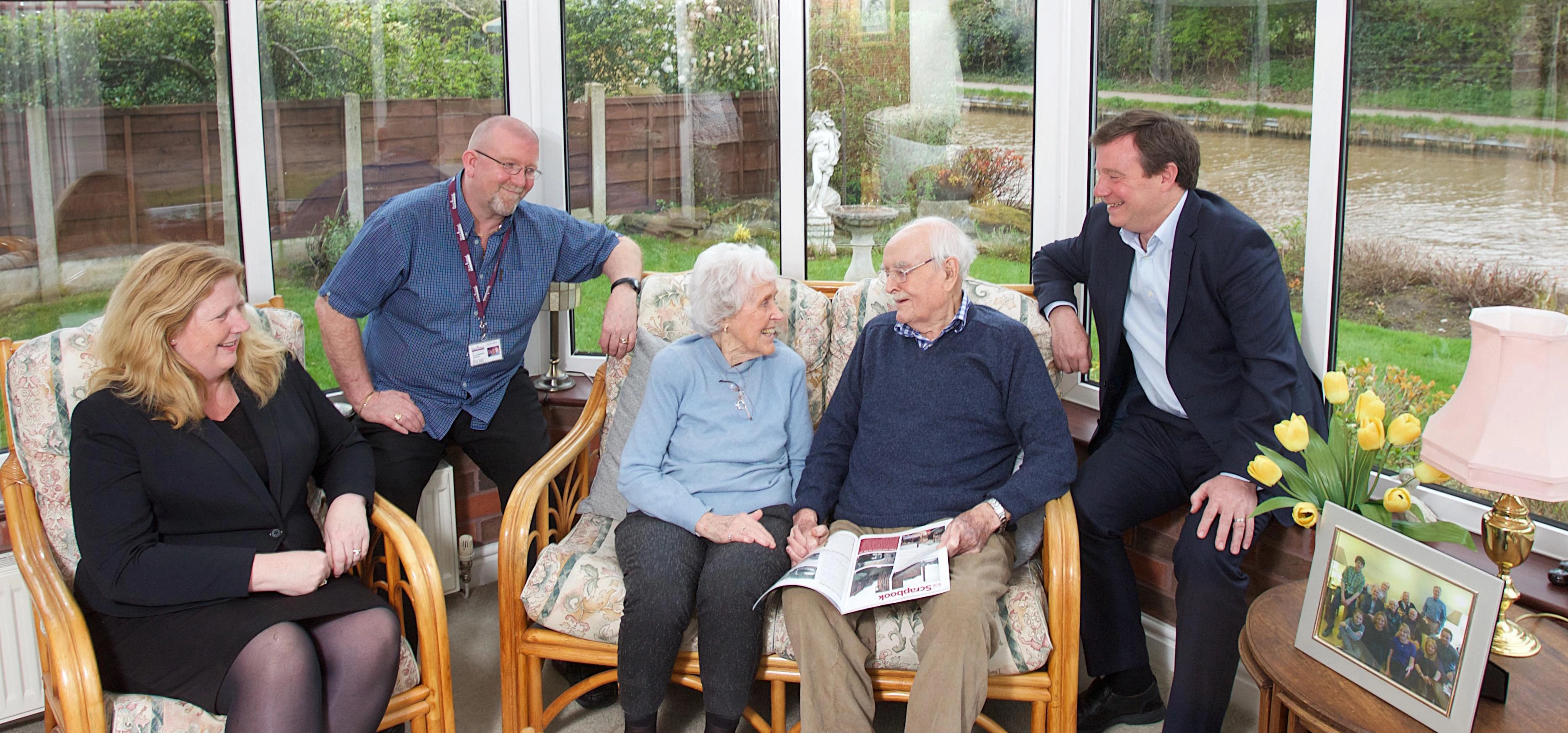 Home Instead Senior Care co-founder Sam Brocklebank, CAREGiver Patrick, clients Marie and Varley and