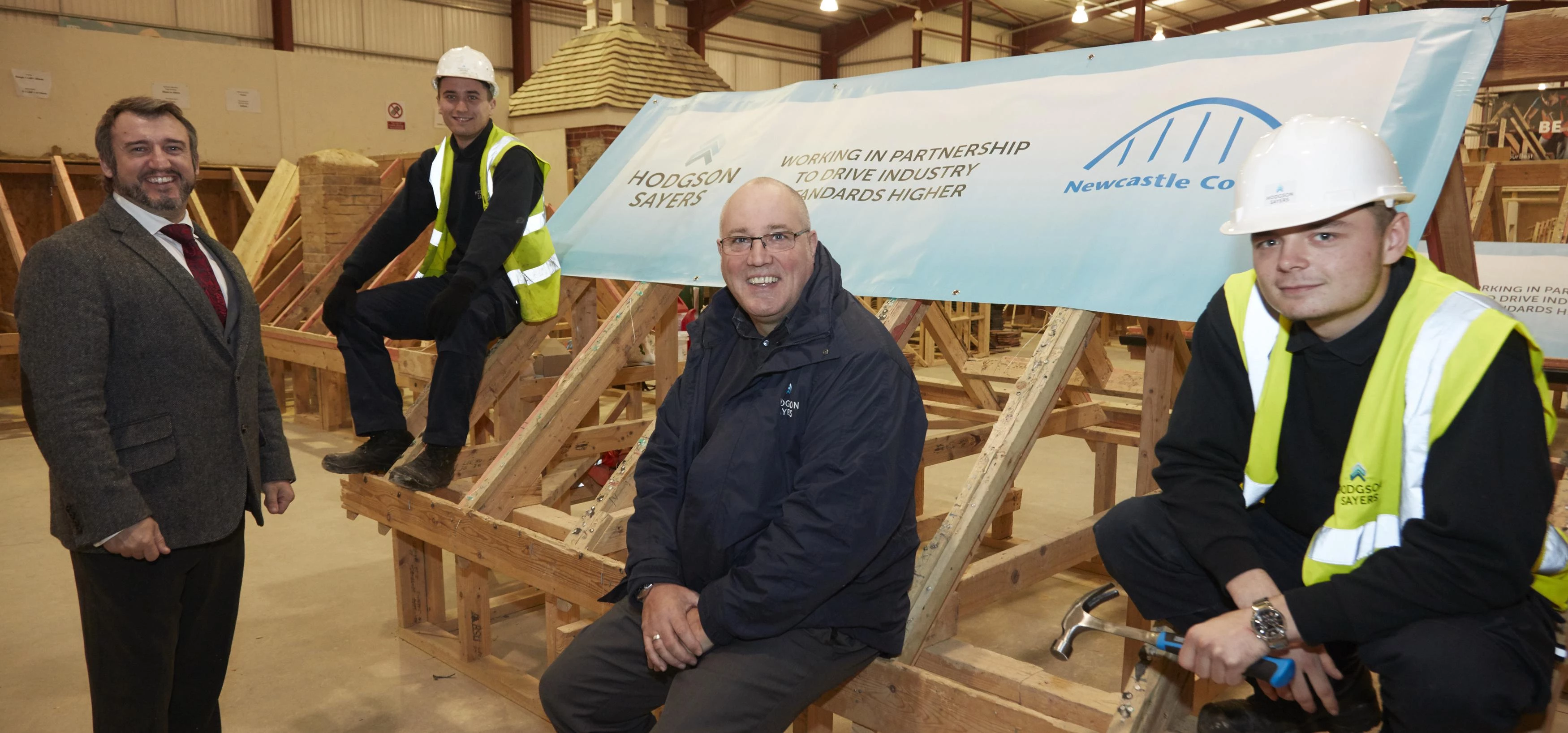 Construction director at Newcastle college Darren Carr, apprentice David Bilverstone, regulatory aff