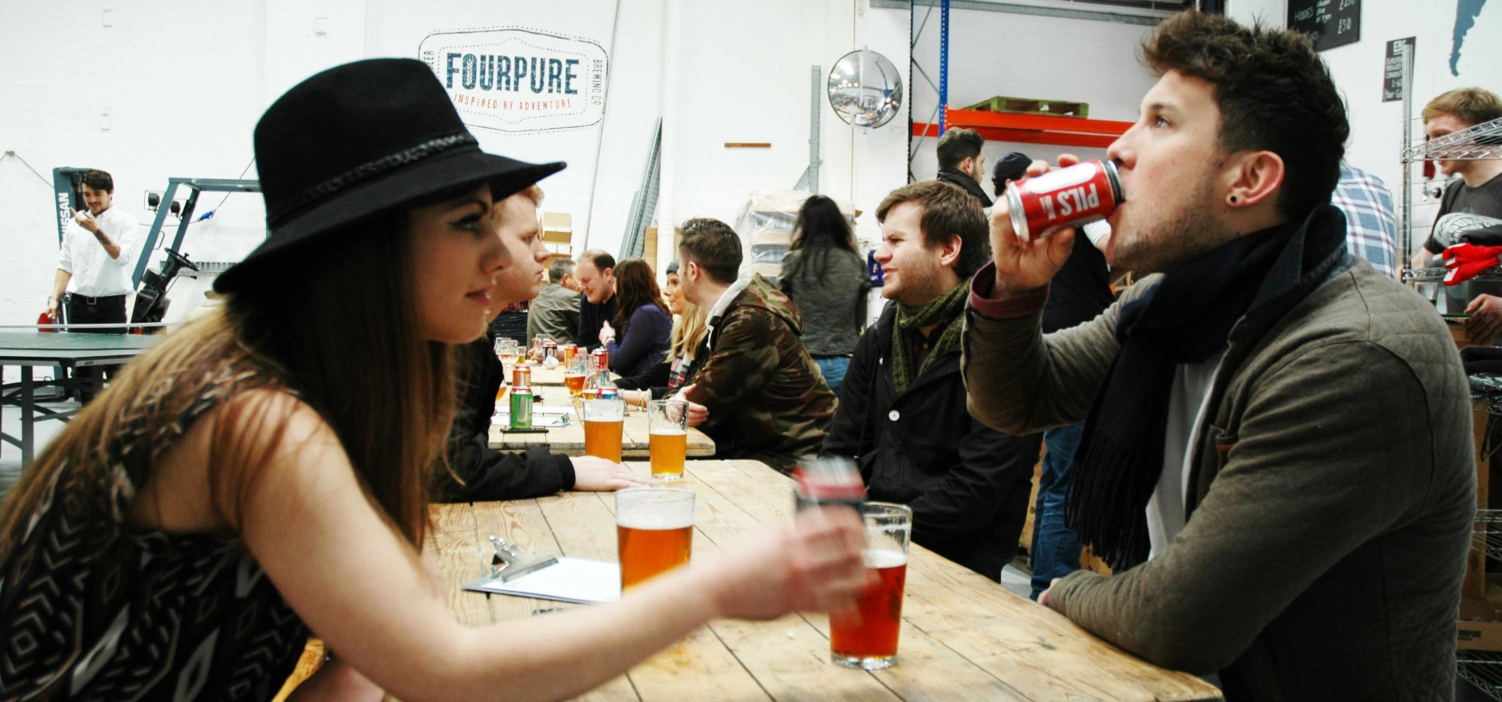 Drinkers enjoying a can at FourPure taproom