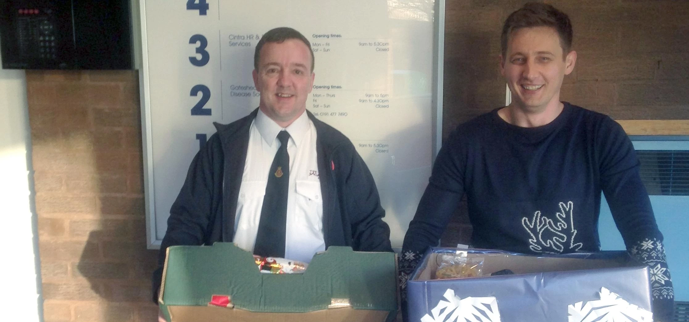Mark Storey from the Salvation Army collecting the donations from Cintra HR & Payroll Services Burea