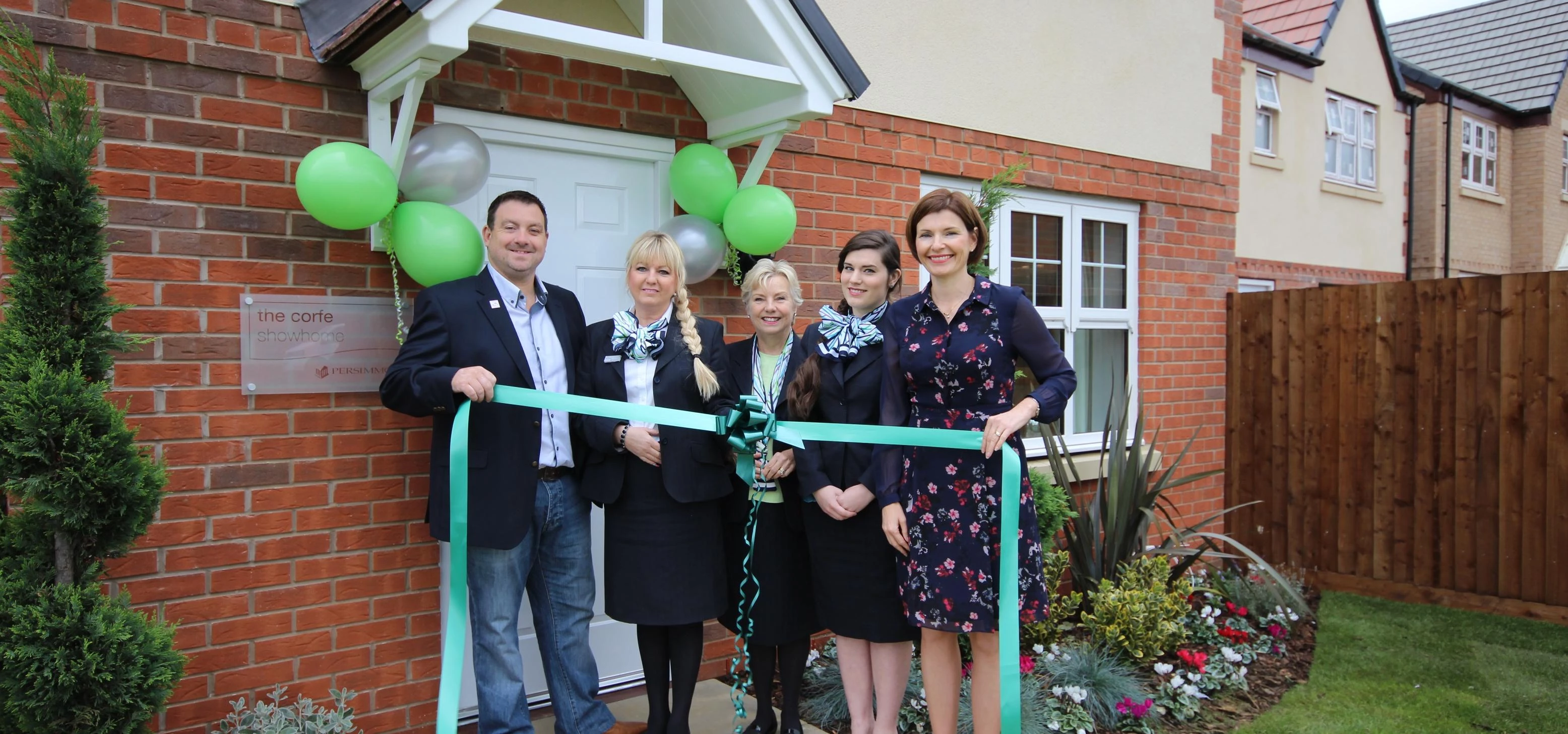 From left, Chris Curry of Niamh’s Next Step cuts the ribbon to open the Harlestone Manor showhome wi