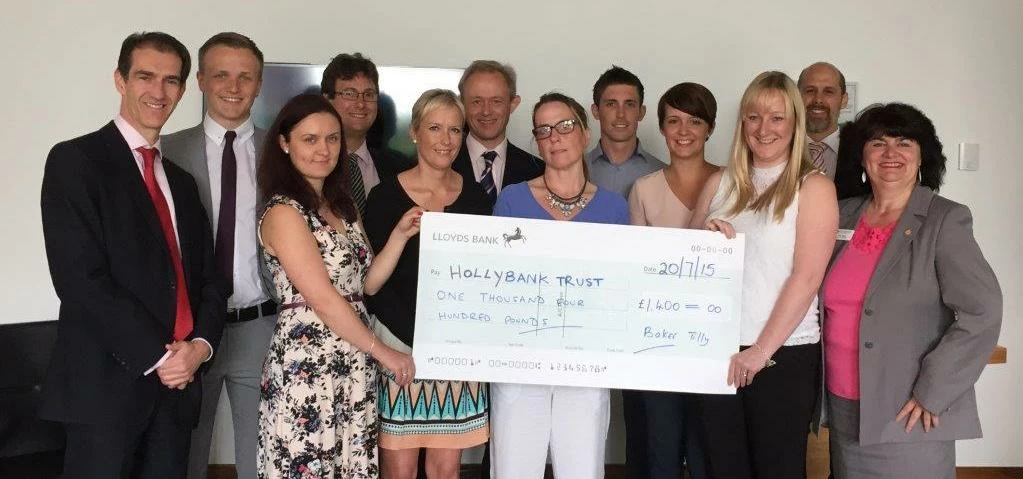 The Baker Tilly 10K team present a cheque to the Hollybank Trust