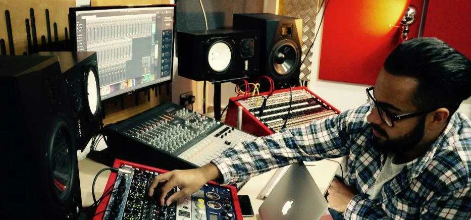 Dom Smith, sound engineer at a studio desk. 