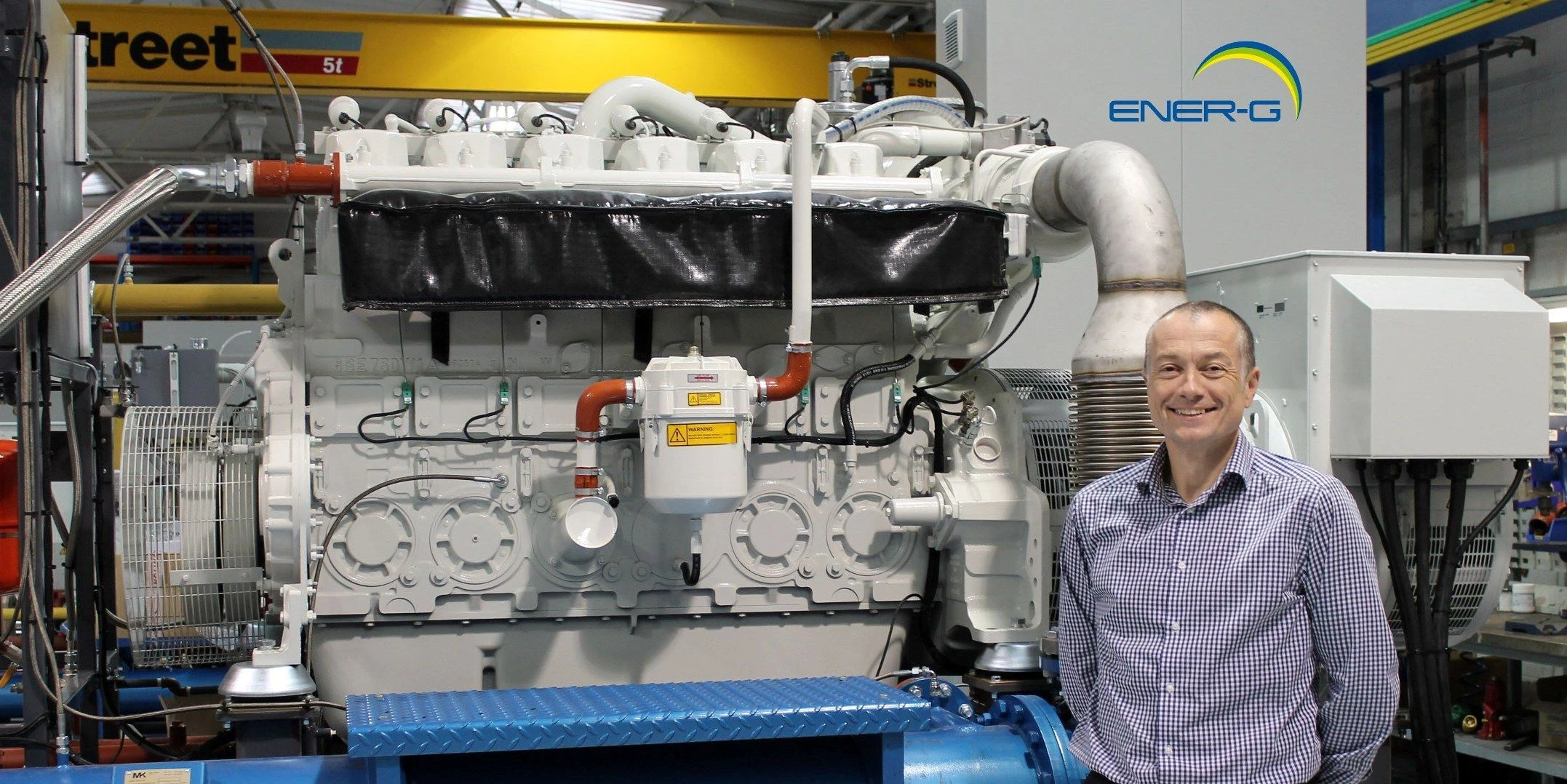 Chris Marsland, Technical Director of ENER-G Combined Power Ltd, with ENER-G CHP system 