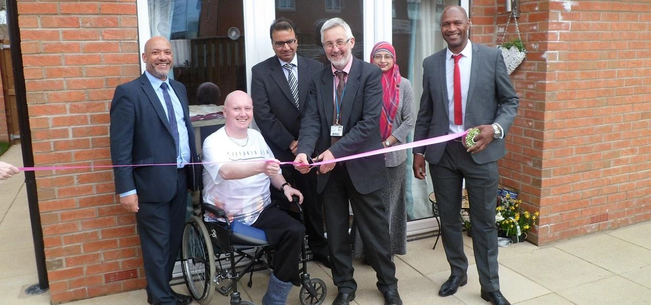 Cllr Richard Lewis cuts the ribbon to officially open Rocheford Court, assisted  by Unity chief exec