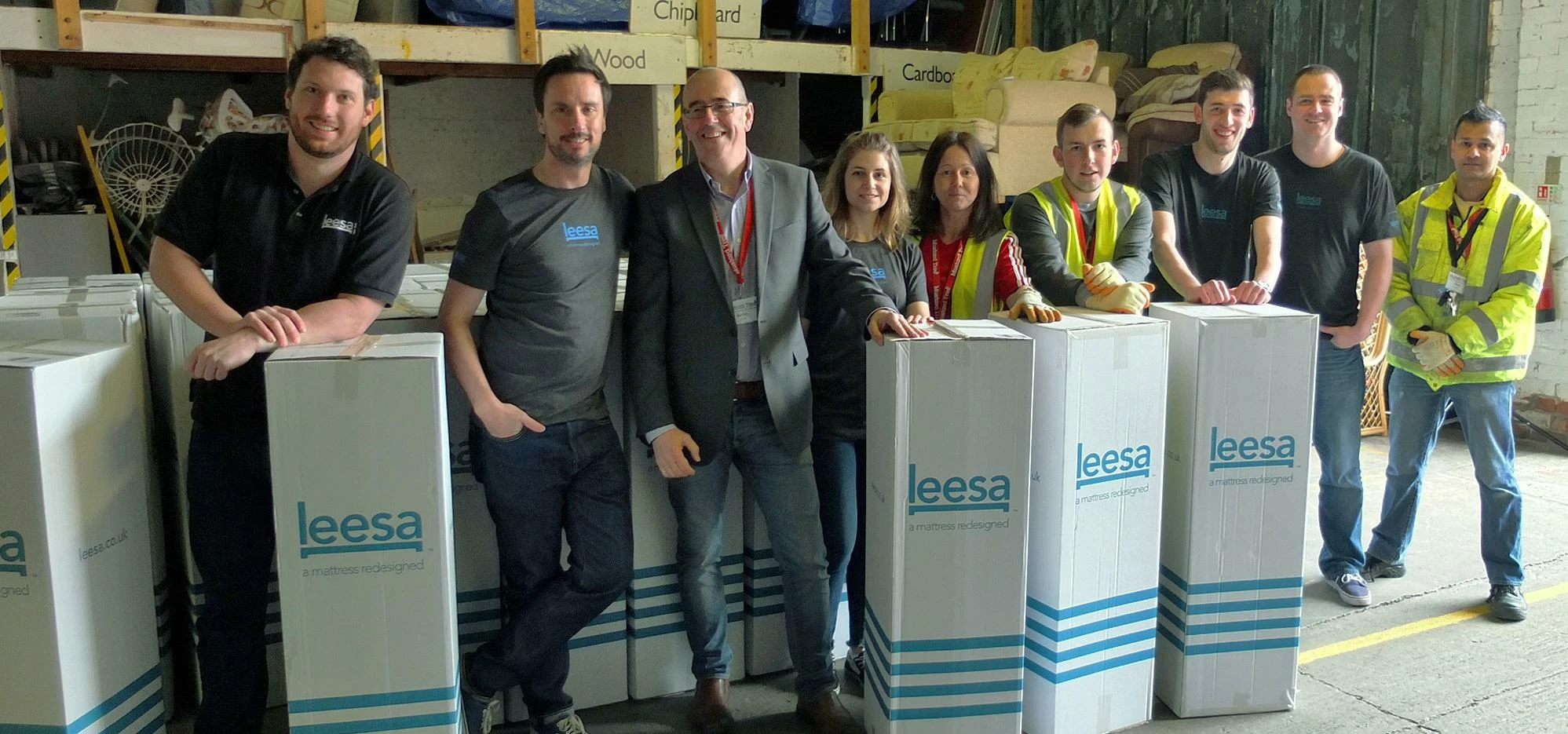 Team members from Leesa UK and Mustard Tree help to unload the mattresses