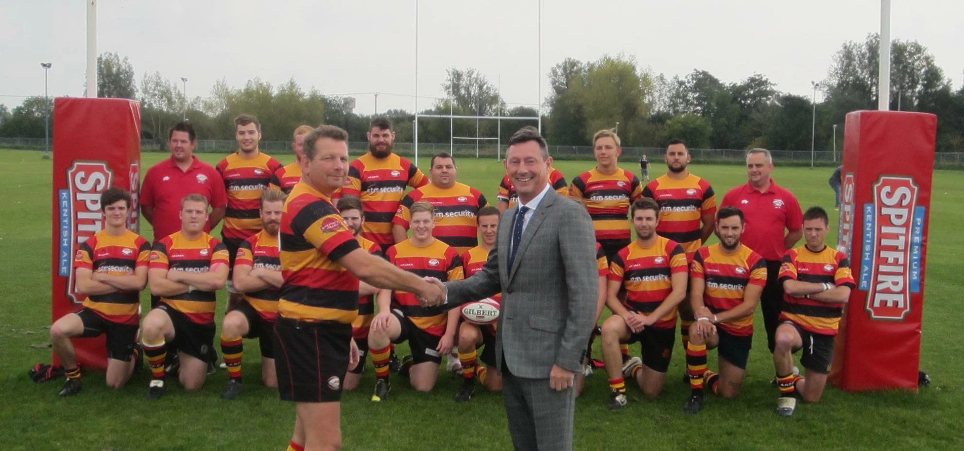 Ashford Rugby Club Chairman John Norman (left) shakes hands on the deal with Colin Griffin, Managing