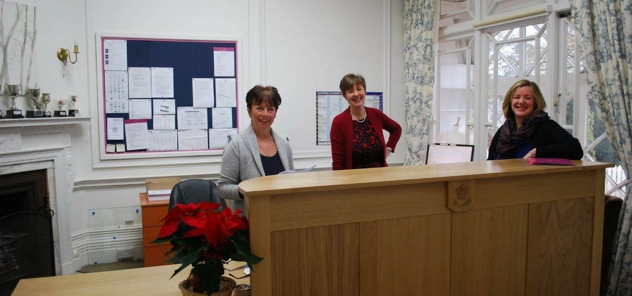 Staff at Cundall Manor School behind their new reception desk