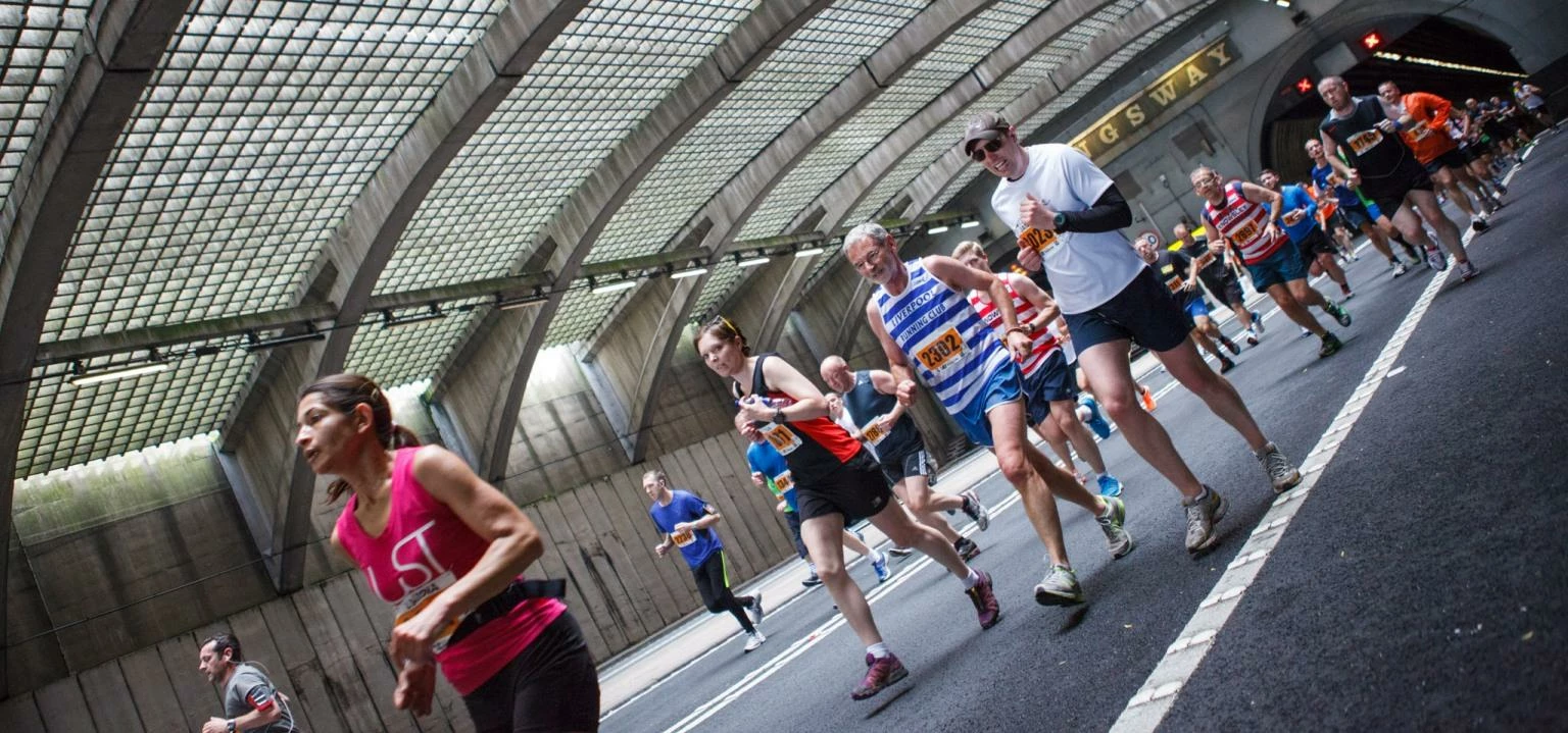 Runners emerging from the Kingsway Tunnel during the BTR Mersey Tunnel 10K 2014. Picture by James St