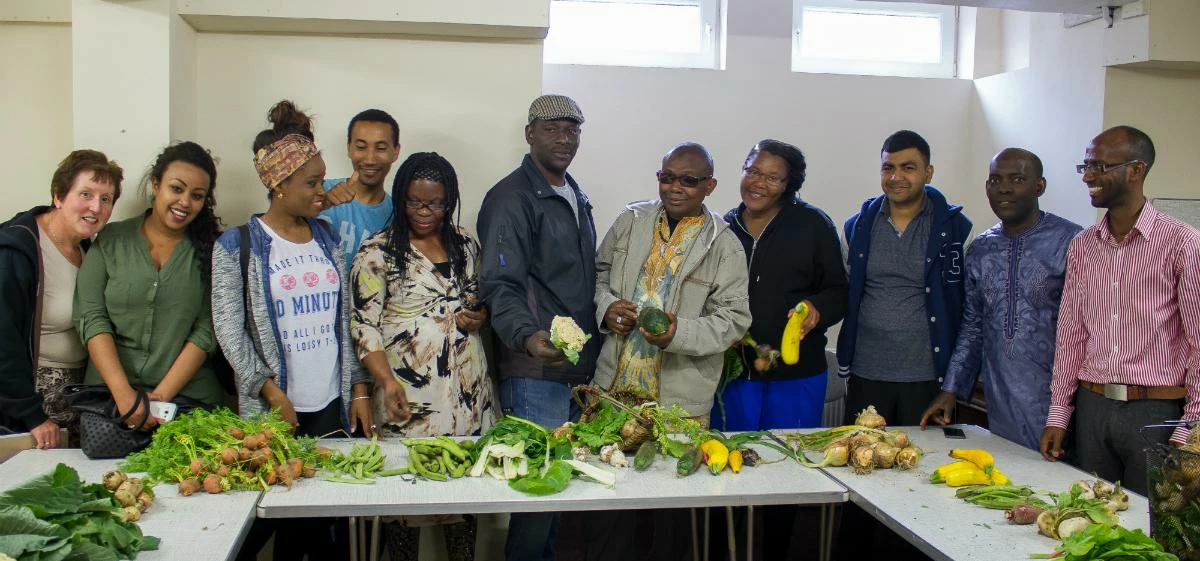 IPC Trustee Bini Araia and the volunteers from the IPC Community Kitchen with some of their home-gro