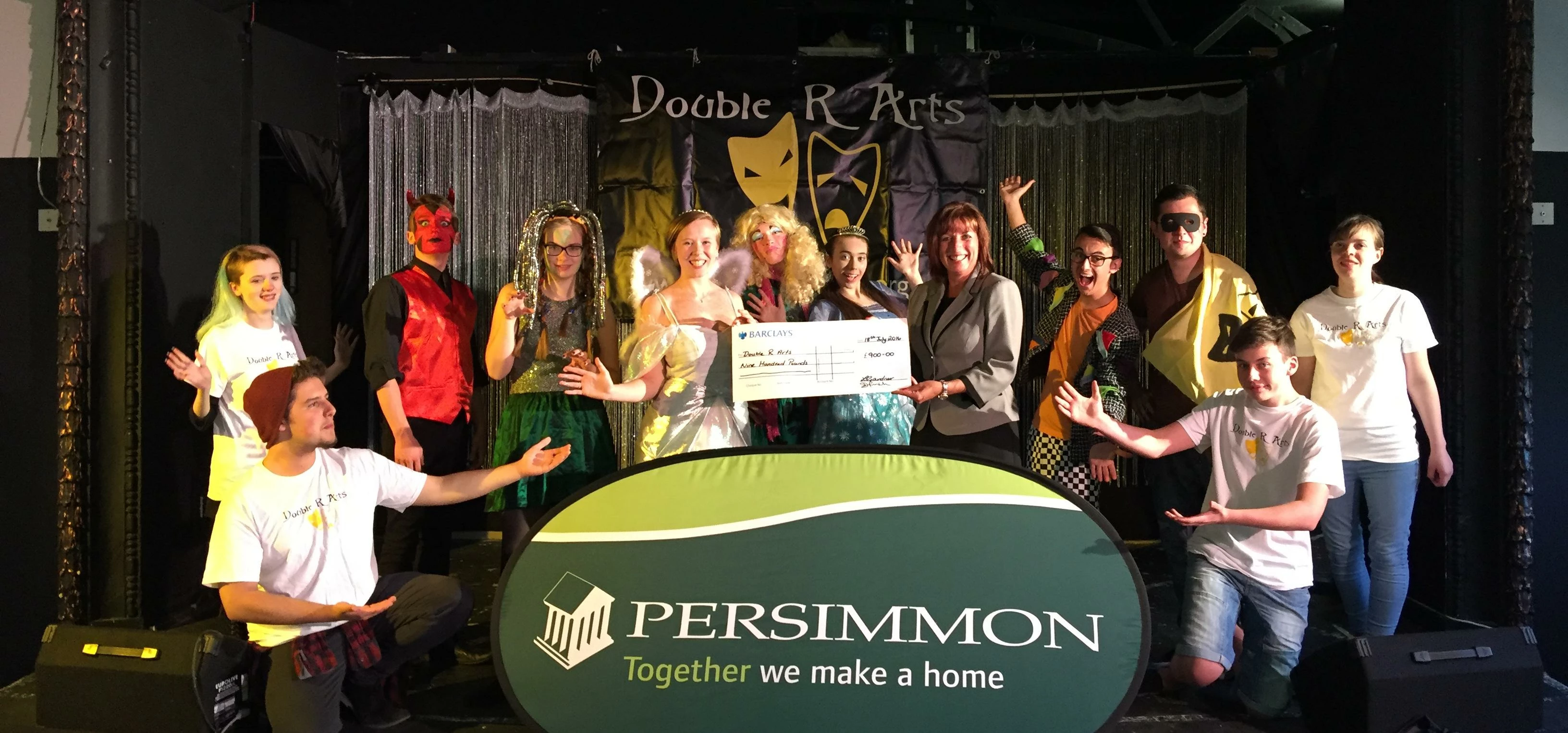 PICTURED: Double R Arts receive a Community Champions cheque from Persimmon Homes sales director Dia