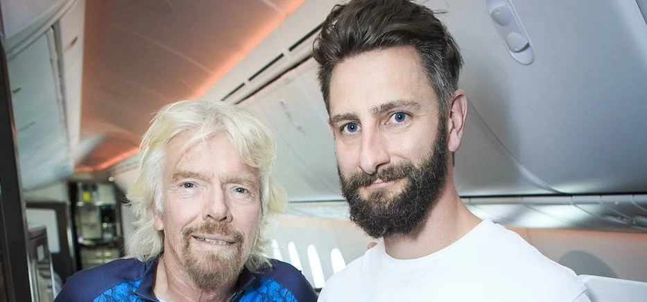 Sir Richard Branson mentors cycling apparel entrepreneur Sam Morgan during a flight from London to D