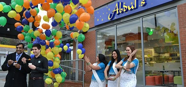 Franchisee Laurence Nair, Councillor Shaffaq Mohammed along with local dance group, Aim To Dance