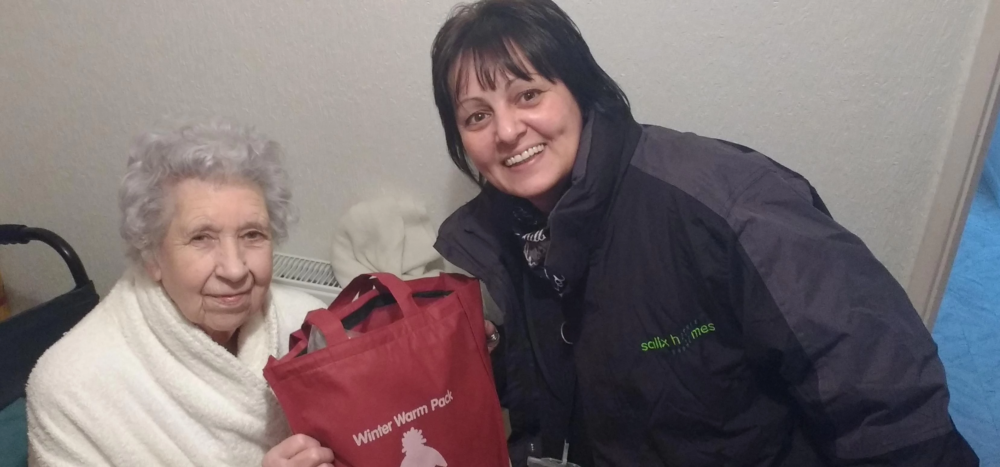 Irene Radcliffee, aged 97, receiving her winter pack off Salix Homes neighbourhood officer, Kay Horr