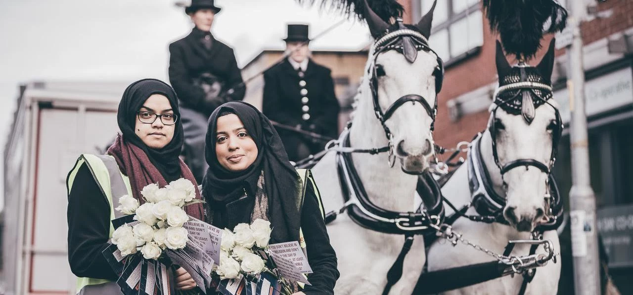 Tahira Shabbir and Fatima Raza with the roses that were handed out.