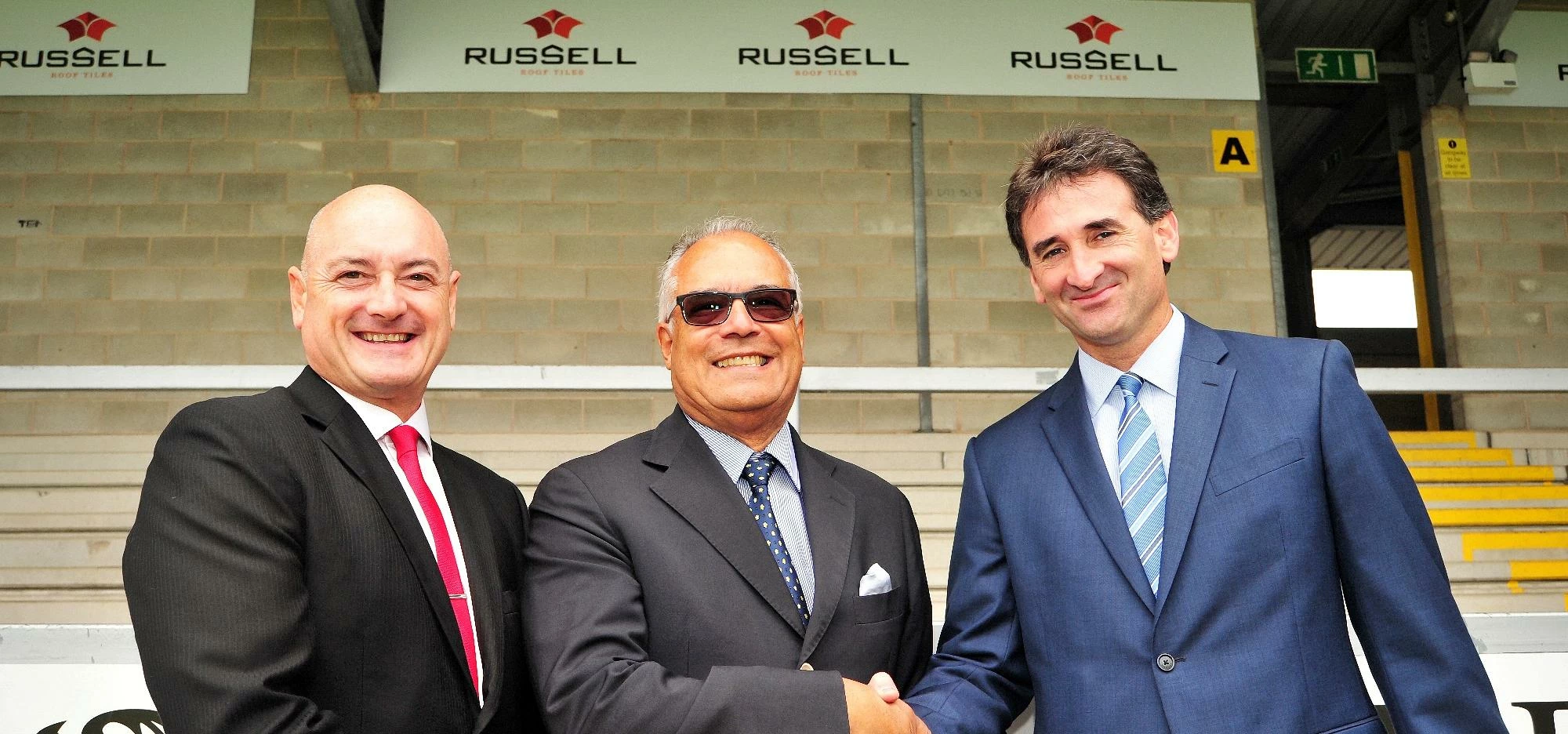 left to right Andrew Hayward from Russell Toof Tiles, Ben Robinson Chairman of Burton Albion FC and 