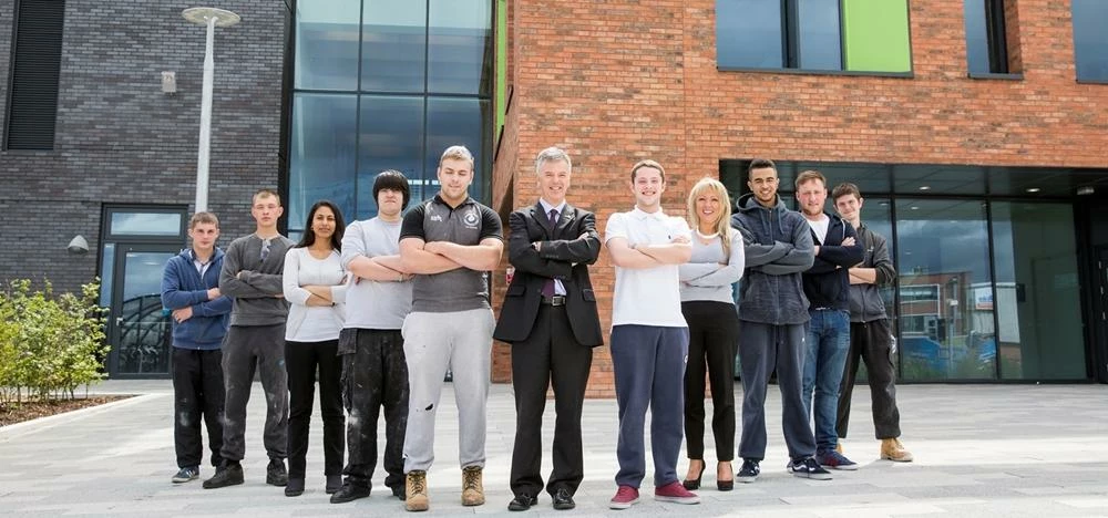 Ian Billyard, Principal at Leeds College of Building with students at the new £17m campus