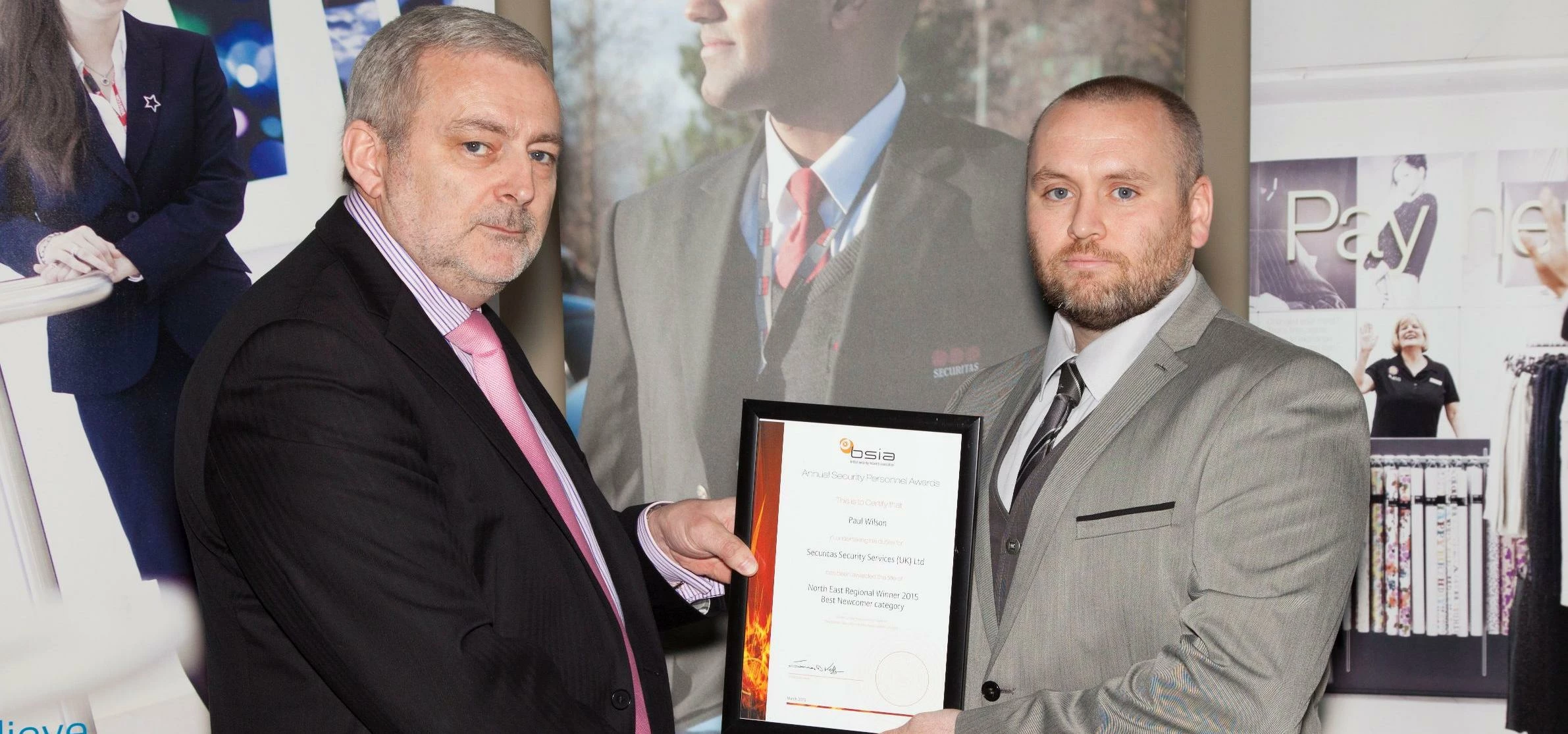 Paul (right) receives his award from BSIA Director, Trevor Elliot