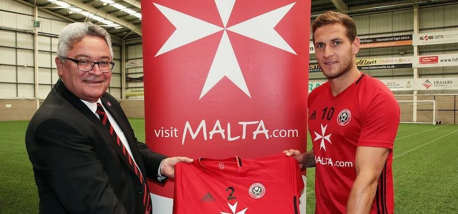 (L – R) Victor Bonett (Visit Malta) and Sheffield United striker Billy Sharp.