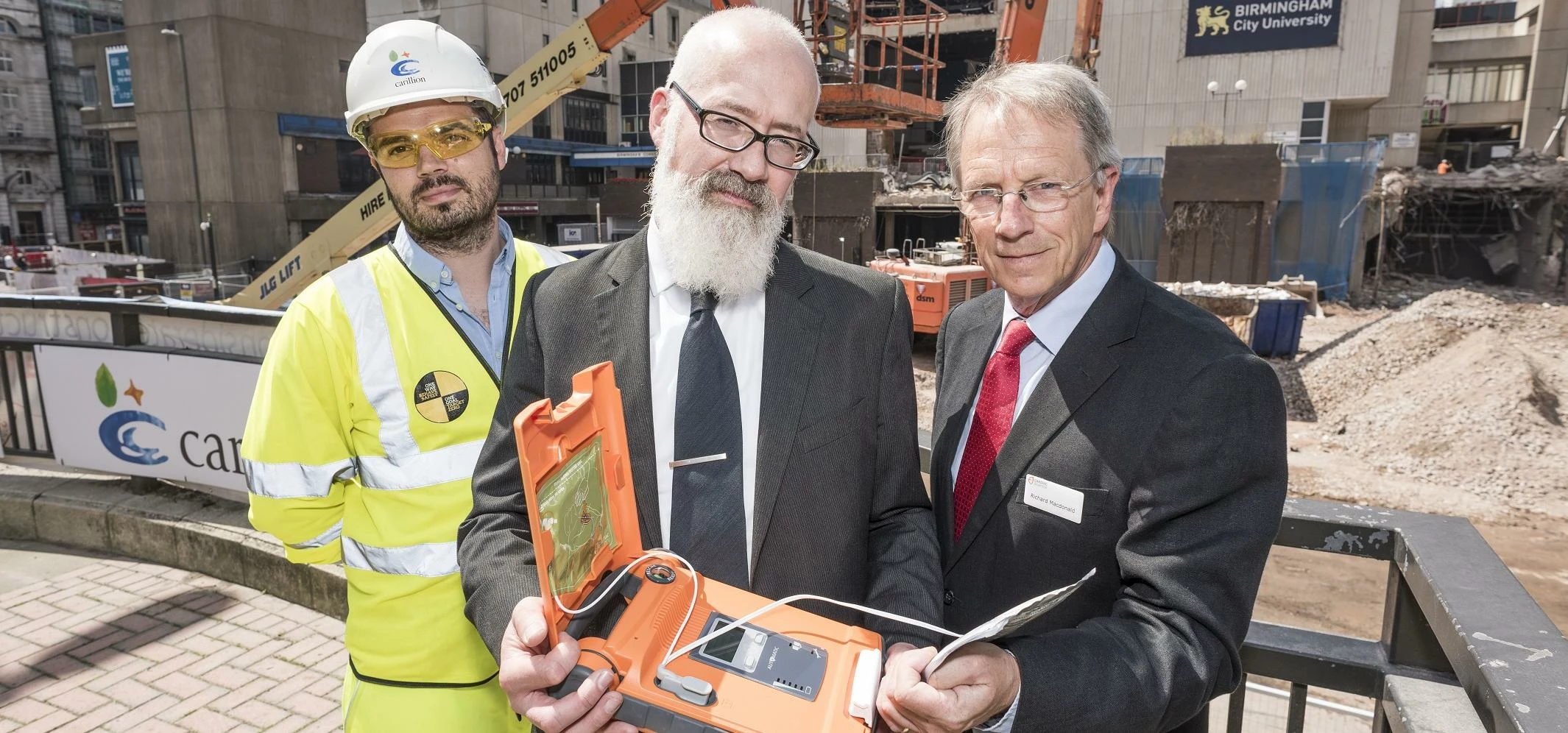 Glenn Christiansen (centre) with a Carillion colleague and Richard MacDonald from Cardiac Science (r